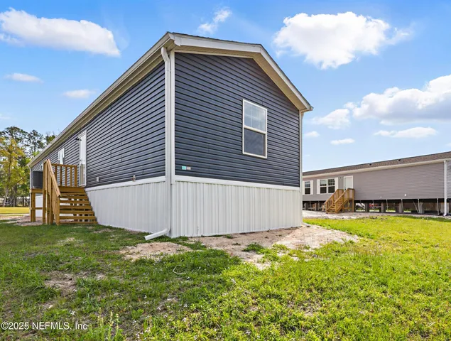 a view of a house with a backyard