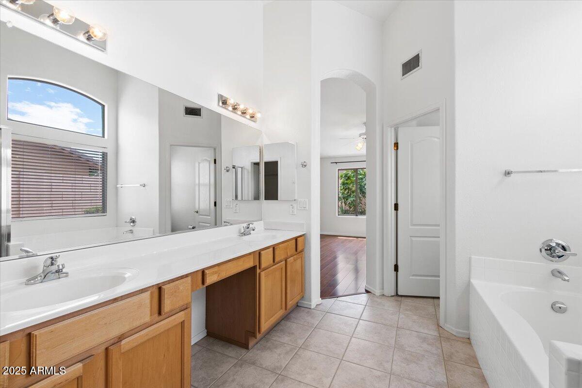 1563 East Robinson Way Chandler, AZ 85225 - Photo 12 of 21 a spacious bathroom with a bathtub sink and mirror
