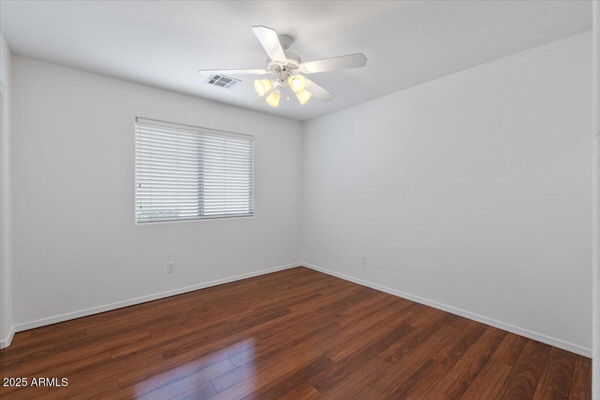 1563 East Robinson Way Chandler, AZ 85225 - Photo 17 of 21 a view of an empty room with wooden floor and a fan