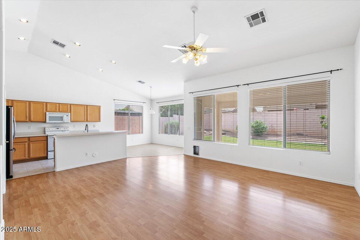 1563 East Robinson Way Chandler, AZ 85225 - Photo 2 of 21 a view of an empty room with a window and wooden floor