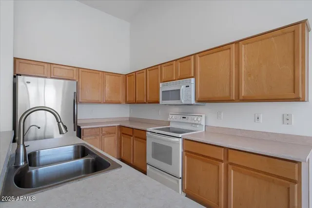 a kitchen with a sink cabinets and appliances