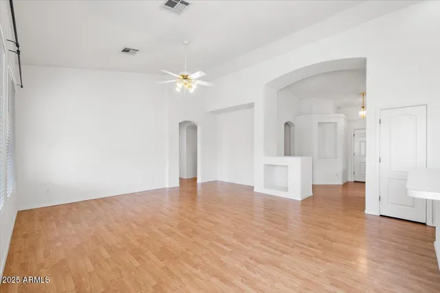 a view of an empty room with wooden floor
