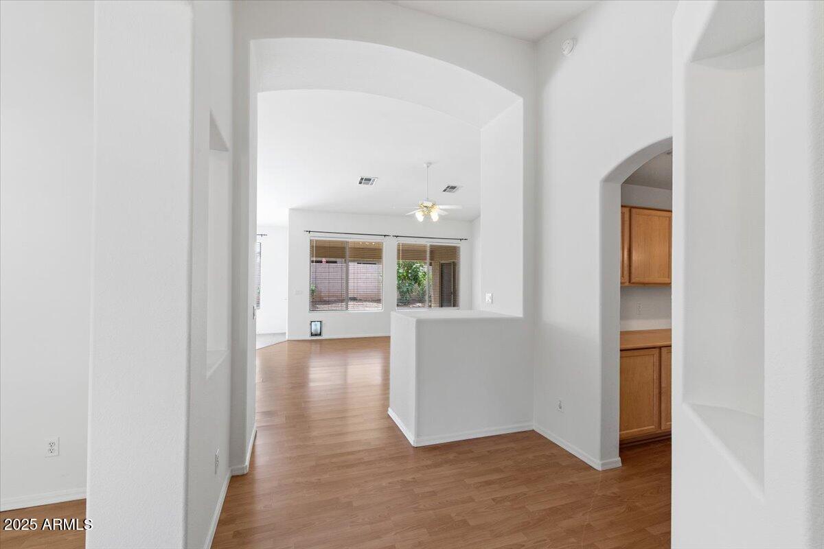1563 East Robinson Way Chandler, AZ 85225 - Photo 9 of 21 a view of a hallway with wooden floor and a living room