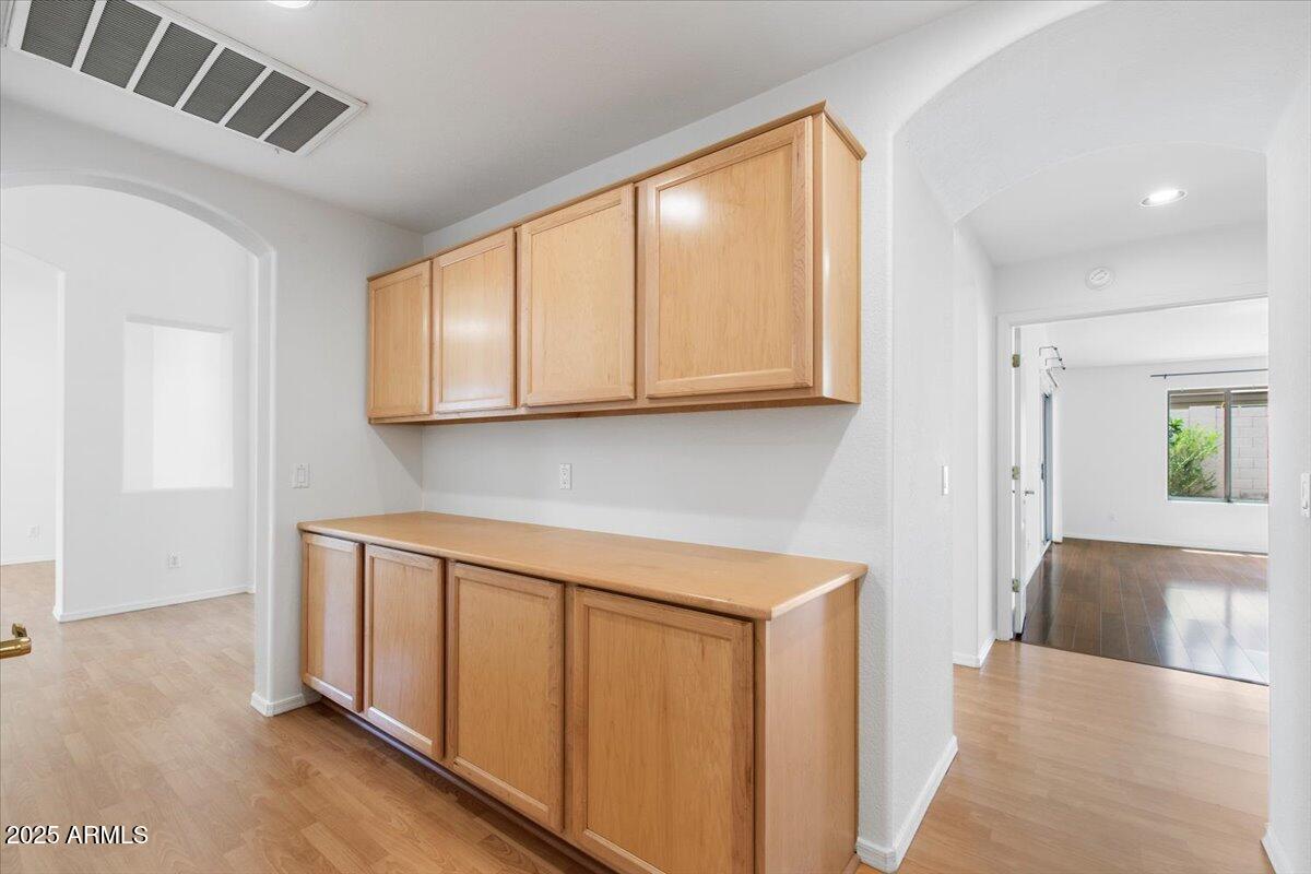 1563 East Robinson Way Chandler, AZ 85225 - Photo 10 of 21 a view of a kitchen with wooden floor and cabinets