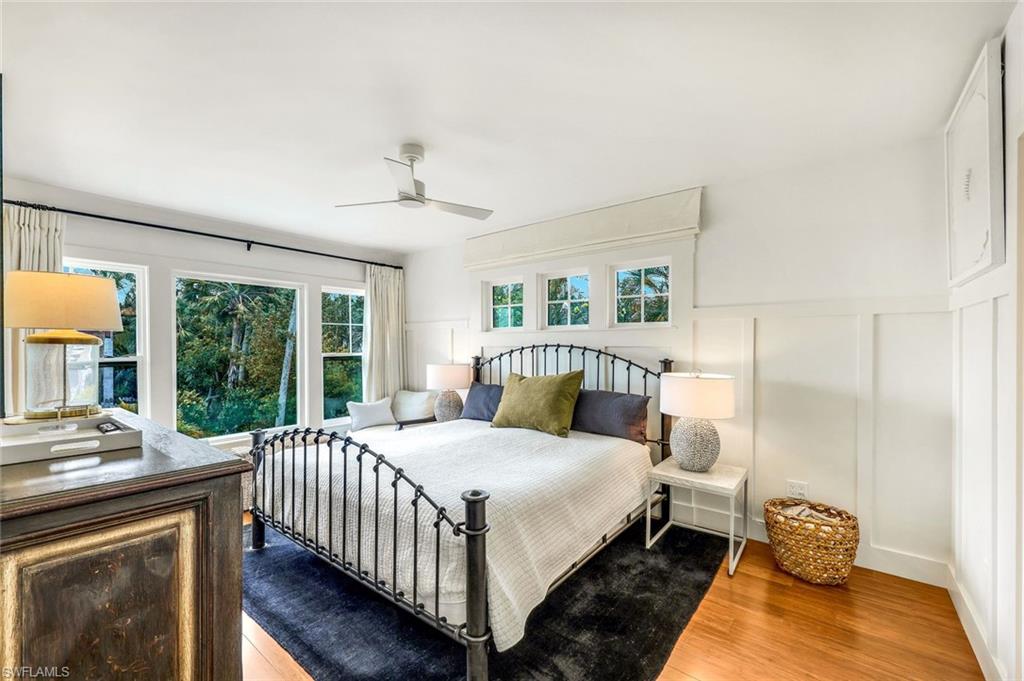 1437 Sandpiper Street Naples, FL 34102 - Photo 15 of 38 a bedroom with a bed and a large window