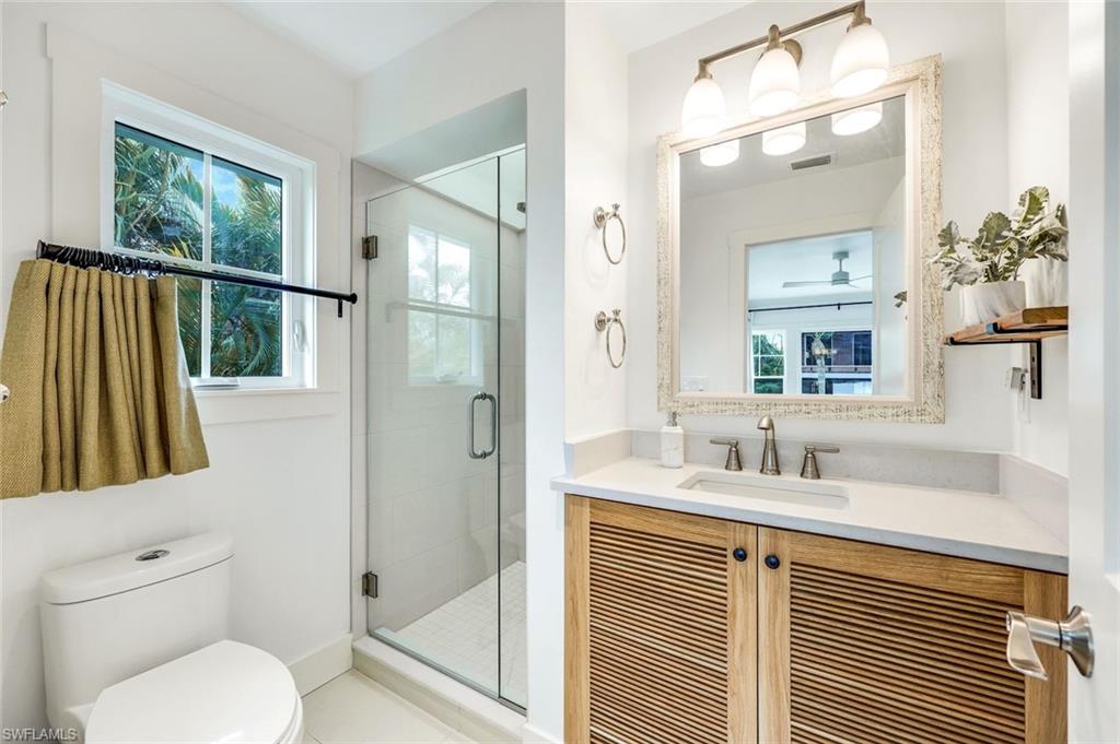 1437 Sandpiper Street Naples, FL 34102 - Photo 16 of 38 a bathroom with a sink toilet and shower