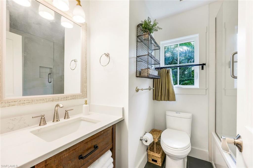 1437 Sandpiper Street Naples, FL 34102 - Photo 19 of 38 a bathroom with a sink a toilet and shower