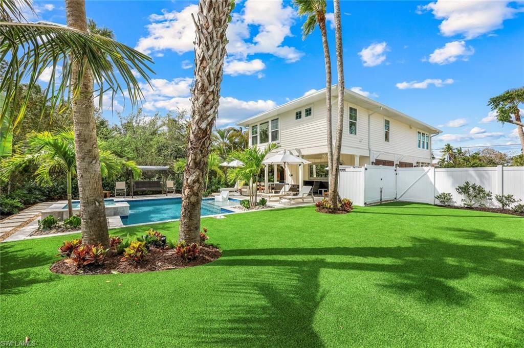 1437 Sandpiper Street Naples, FL 34102 - Photo 26 of 38 a view of a house with a yard