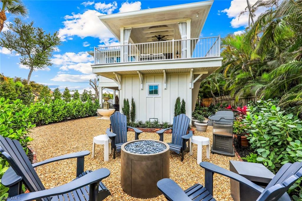 1437 Sandpiper Street Naples, FL 34102 - Photo 27 of 38 a view of a patio with couches table and chairs and potted plants
