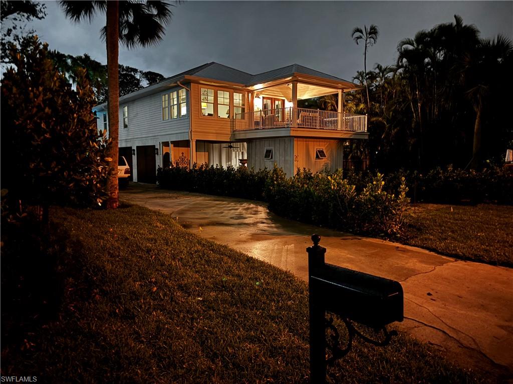 1437 Sandpiper Street Naples, FL 34102 - Photo 34 of 38 a view of a house with a yard balcony and sitting area