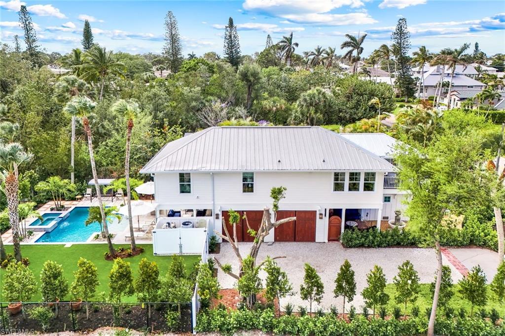 1437 Sandpiper Street Naples, FL 34102 - Photo 4 of 38 an aerial view of a house with yard and outdoor seating