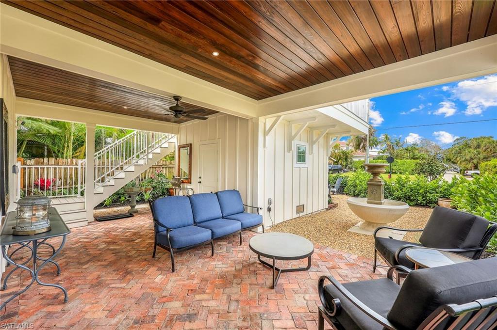 1437 Sandpiper Street Naples, FL 34102 - Photo 6 of 38 a outdoor living space with furniture and garden view