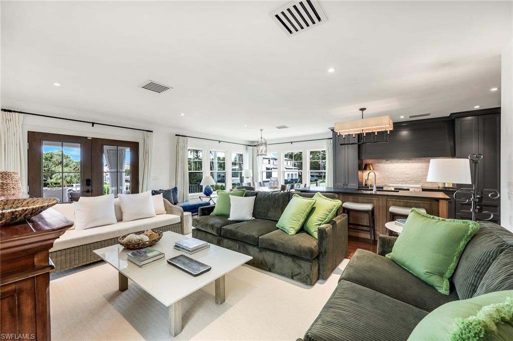 1437 Sandpiper Street Naples, FL 34102 - Photo 9 of 38 a living room with furniture and a large window