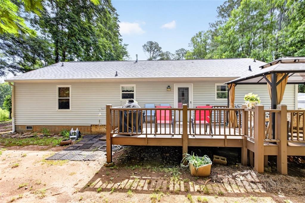 3771 Castleberry Road Cumming, GA 30040 - Photo 46 of 69 a view of a wooden deck with furniture