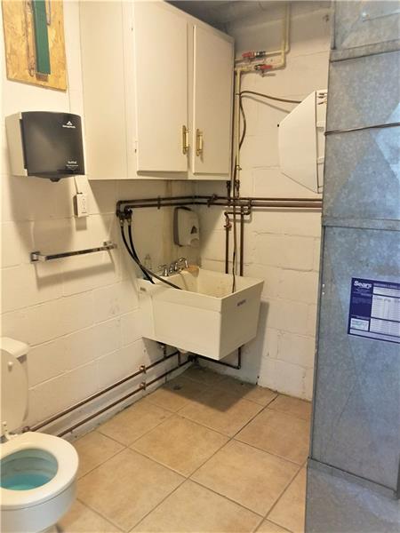 207 Reo Street Butler, PA 16001 - Photo 21 of 25 1/2 bath off of the garage with laundry work sink.