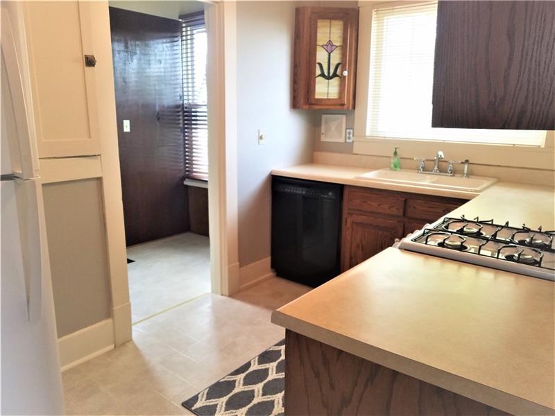 207 Reo Street Butler, PA 16001 - Photo 6 of 25 Nicely updated kitchen with new appliances, flooring, solid oak cabinets with all appliances. Bonus room off of kitchen with washer and dryer included.