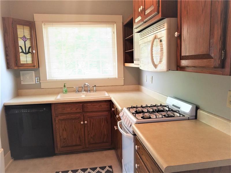207 Reo Street Butler, PA 16001 - Photo 8 of 25 Fully equipped kitchen with all appliances, washer dryer, stain glass corner cabinet and above door way. Lots of cabinets and shelving for all your cook books.