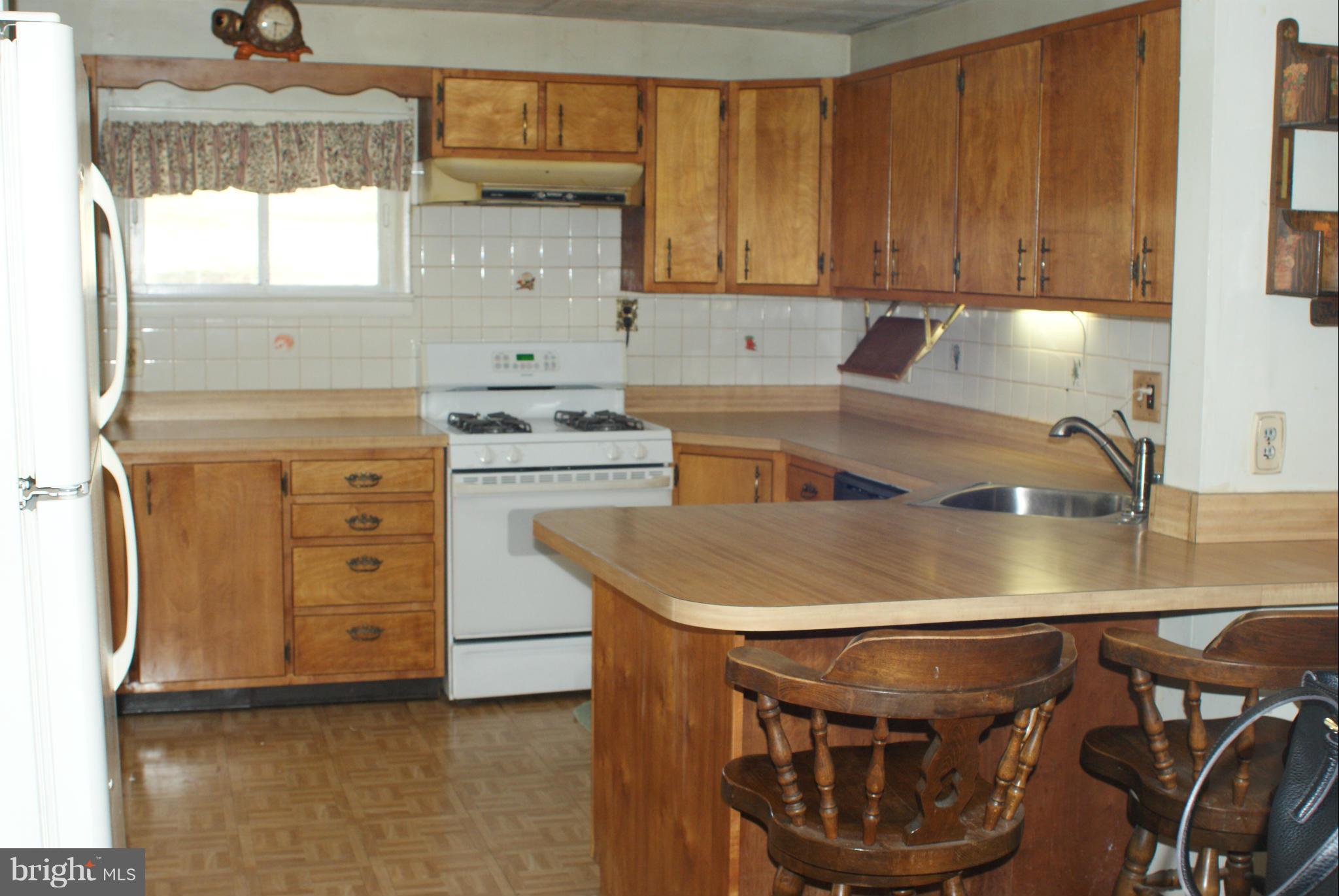 4505 Mahan Road Silver Spring, MD 20906 - Photo 4 of 22 a kitchen with stainless steel appliances granite countertop a sink a stove and a microwave