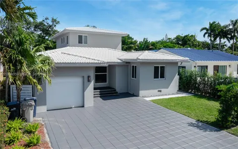 an aerial view of a house with garden space and street view
