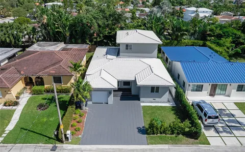 a kitchen with stainless steel appliances a stove a sink a refrigerator and wooden floor