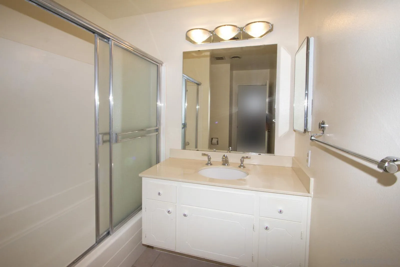 12475 Rios Road San Diego, CA 92128 - Photo 16 of 34 a bathroom with a sink mirror and a shower