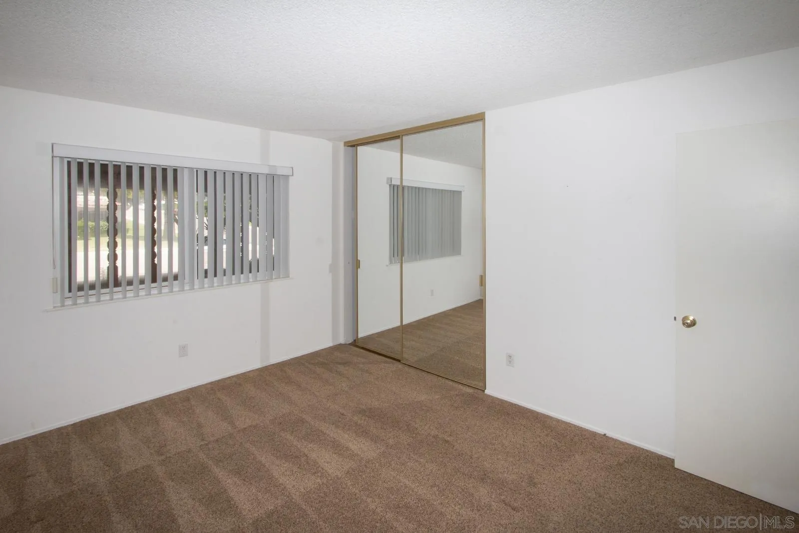 12475 Rios Road San Diego, CA 92128 - Photo 17 of 34 a view of an empty room with a window