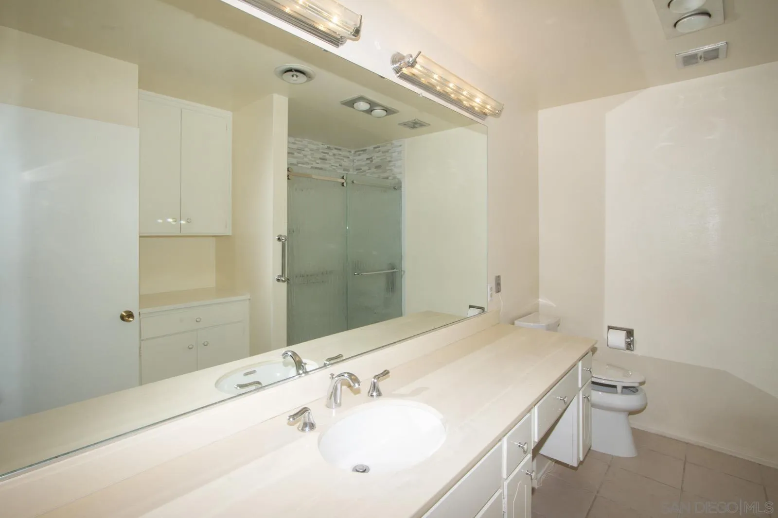 12475 Rios Road San Diego, CA 92128 - Photo 23 of 34 a bathroom with a sink and a mirror