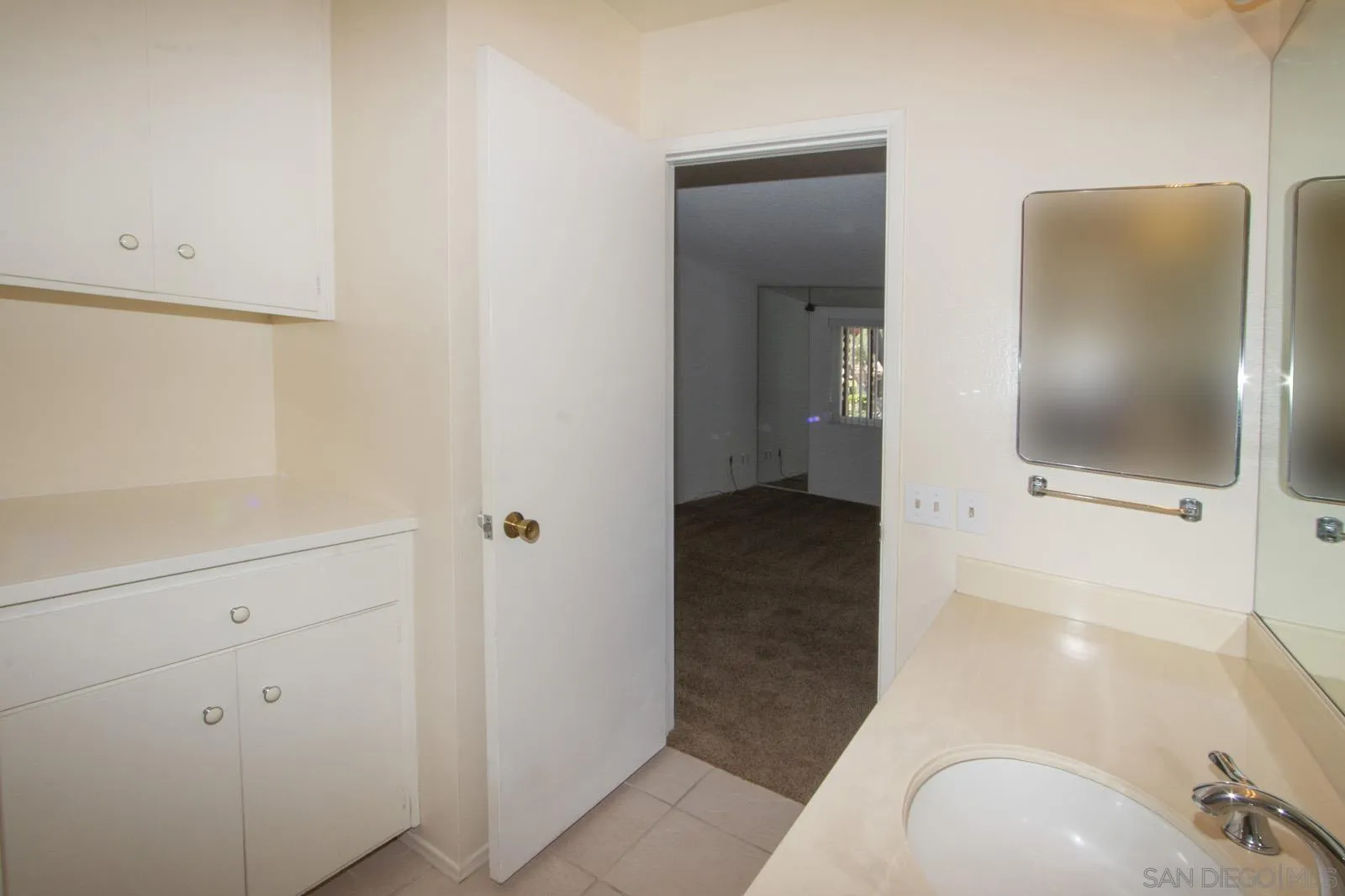 12475 Rios Road San Diego, CA 92128 - Photo 25 of 34 a bathroom with a sink and mirror