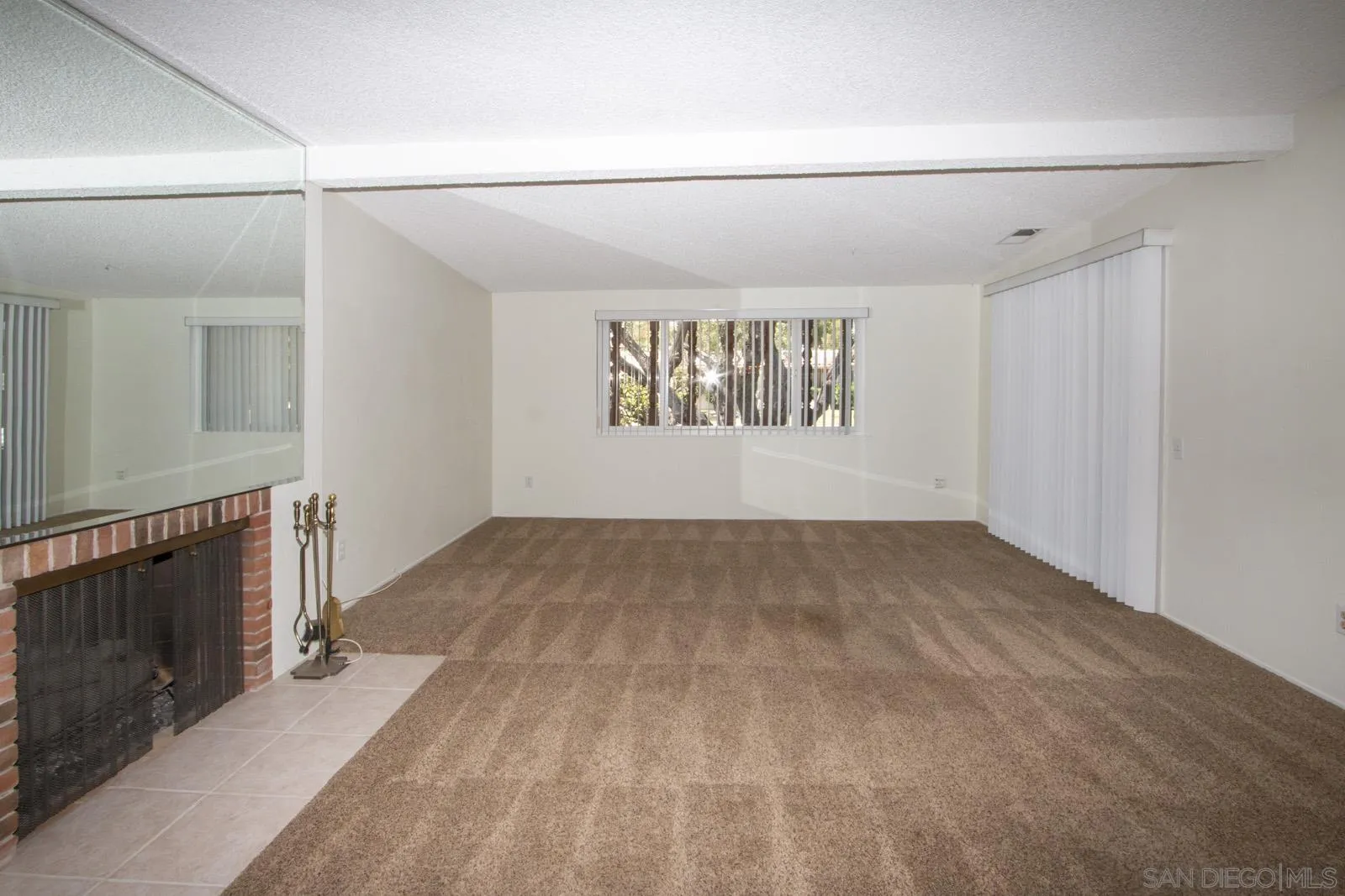 12475 Rios Road San Diego, CA 92128 - Photo 7 of 34 a view of empty room with window and fireplace