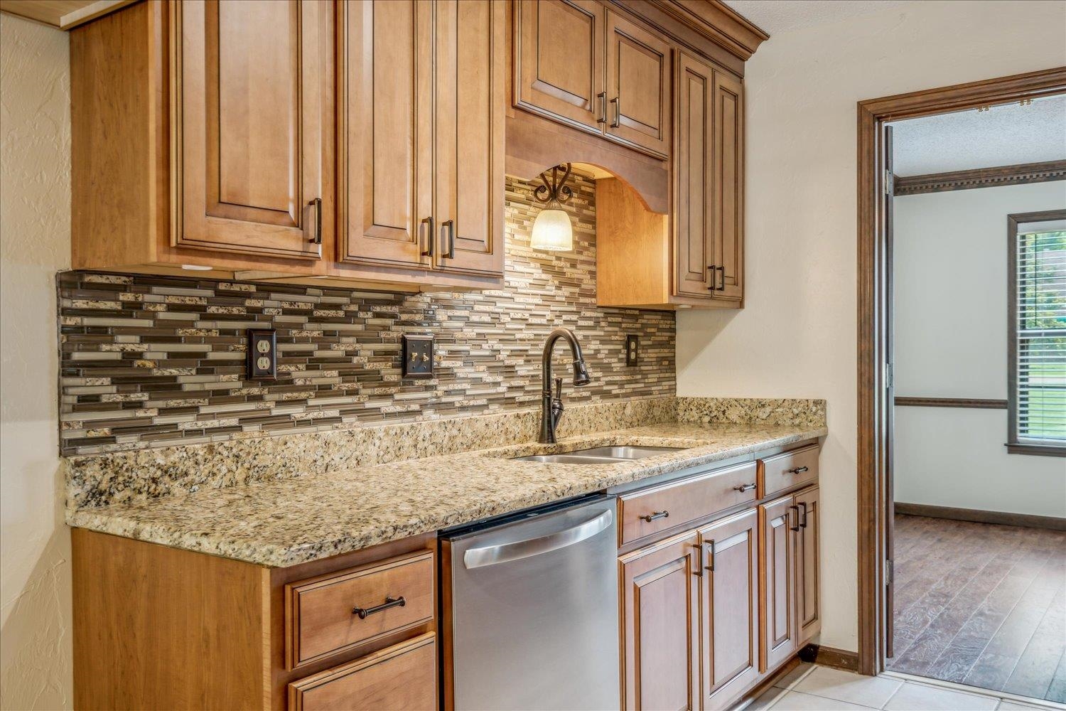 354 College Street Collierville, TN 38017 - Photo 12 of 33 a kitchen with granite countertop a sink and a white stove