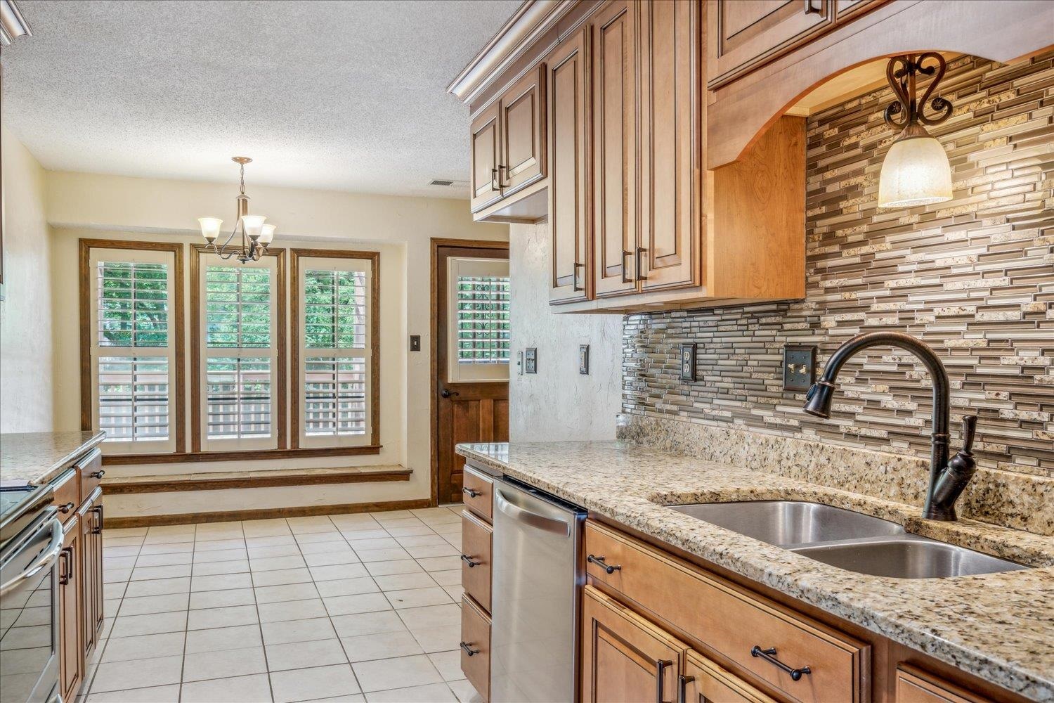 354 College Street Collierville, TN 38017 - Photo 14 of 33 a kitchen with granite countertop a sink and a window