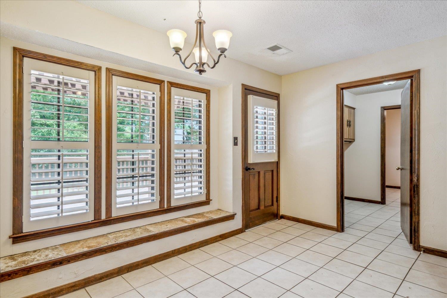 354 College Street Collierville, TN 38017 - Photo 15 of 33 a view of a livingroom with a chandelier fan and windows