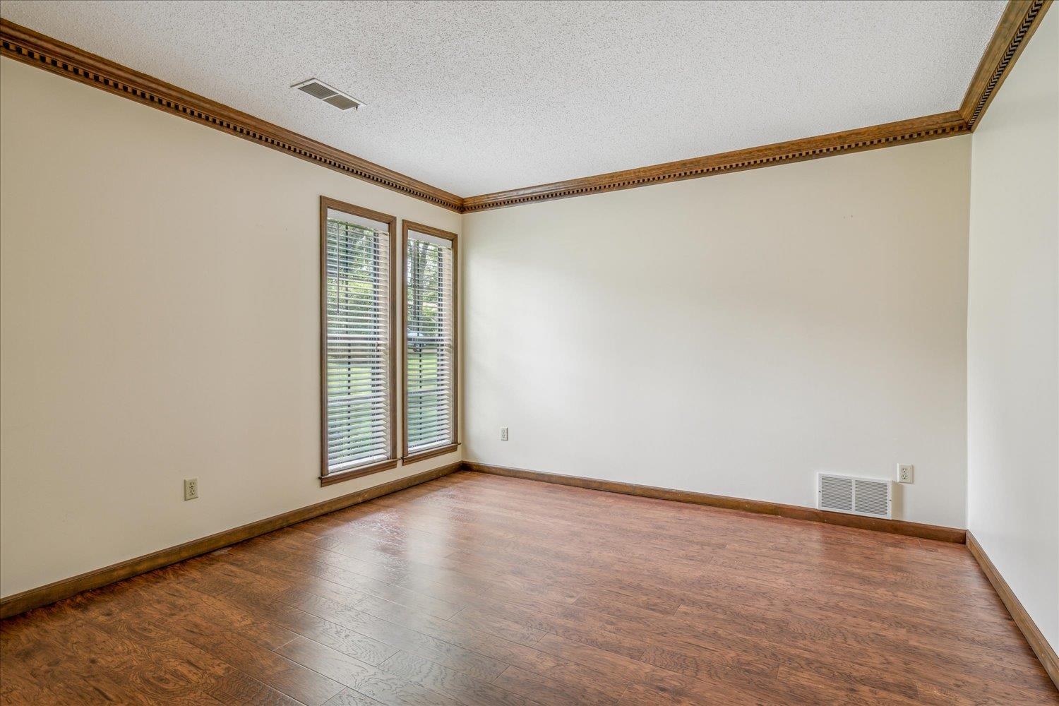 354 College Street Collierville, TN 38017 - Photo 6 of 33 a view of an empty room with wooden floor and a window