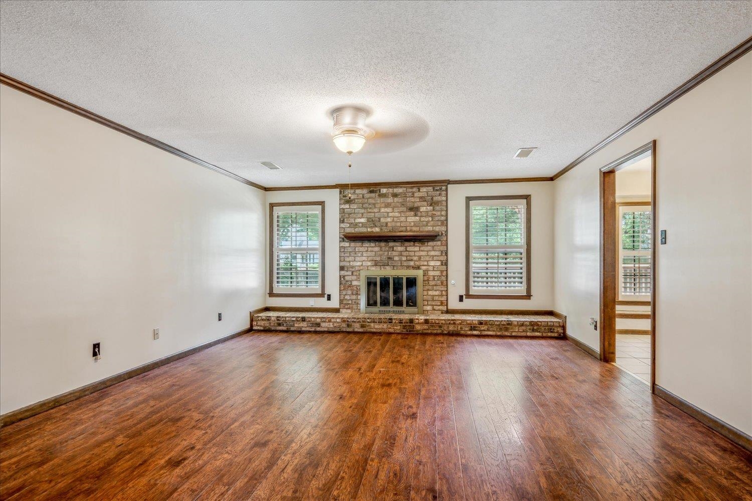 354 College Street Collierville, TN 38017 - Photo 8 of 33 a view of an empty room with wooden floor and a window