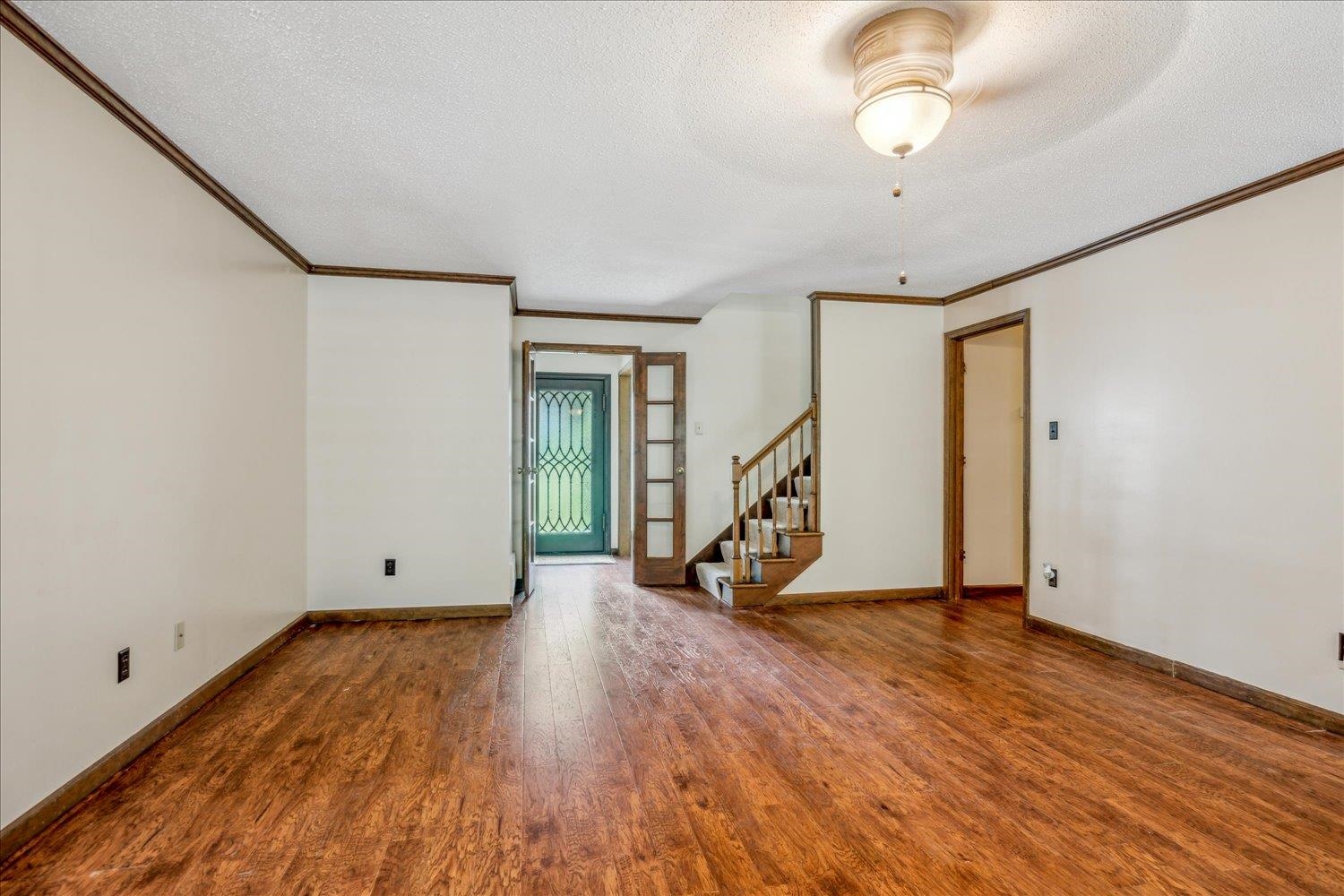 354 College Street Collierville, TN 38017 - Photo 9 of 33 a view of an empty room with wooden floor and stairs