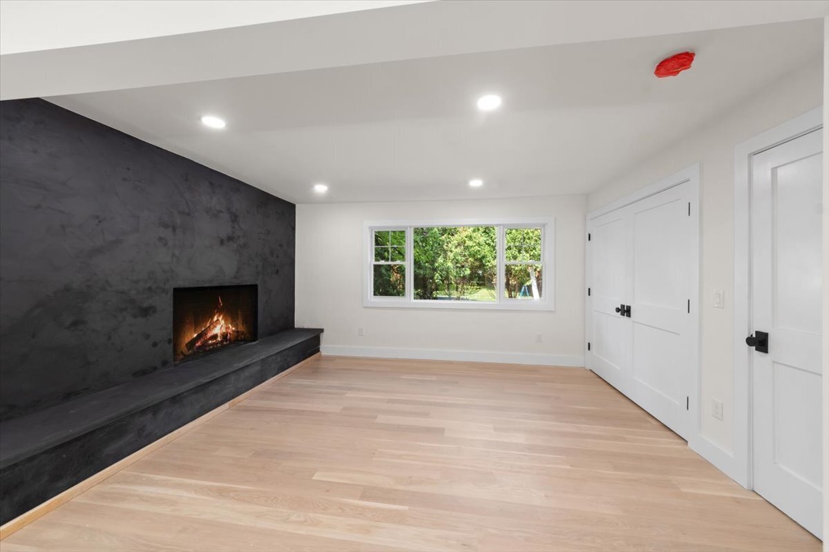 115 Mayfair Road Fairfield, CT 06824 - Photo 13 of 36 an empty room with windows and fireplace