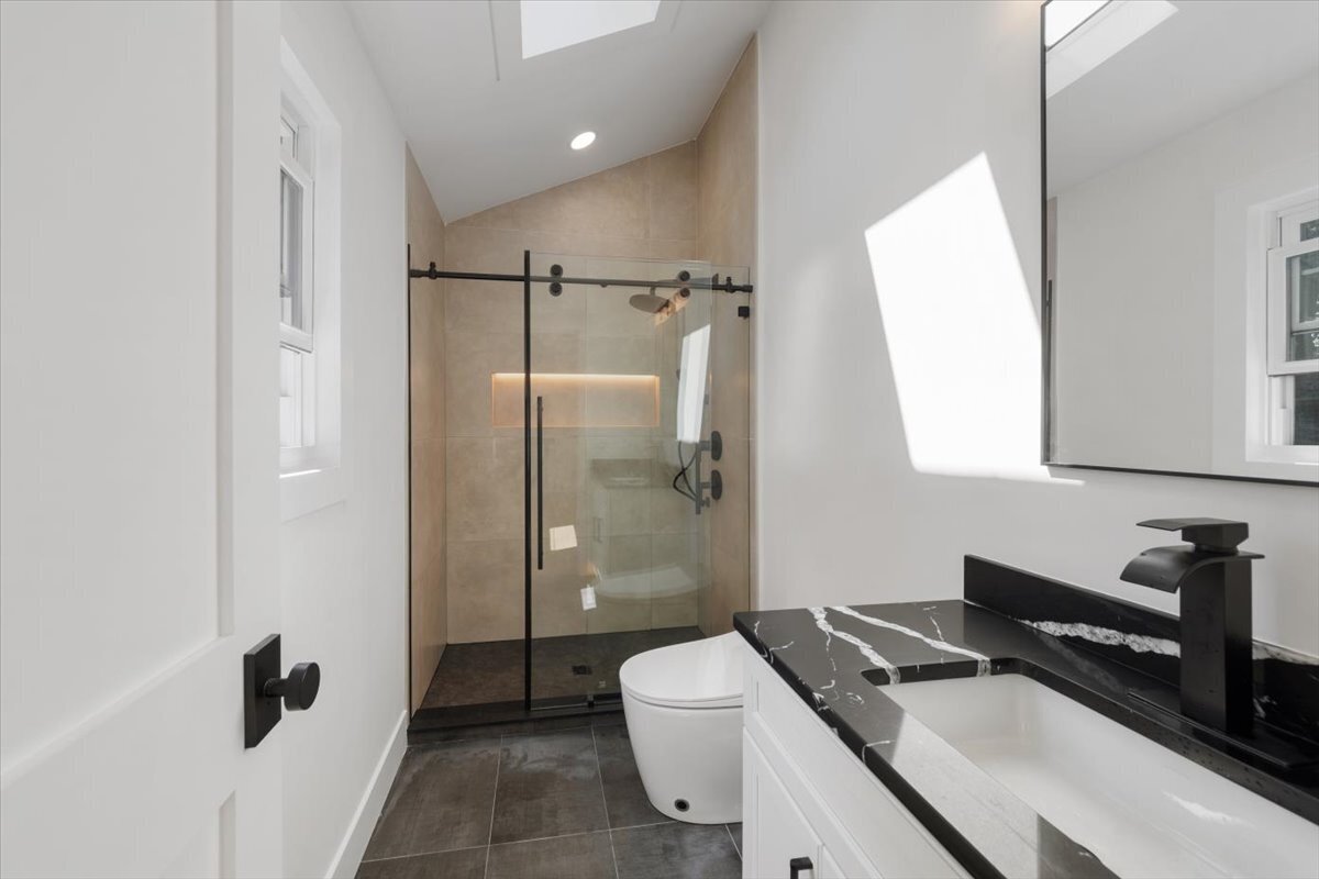 115 Mayfair Road Fairfield, CT 06824 - Photo 22 of 36 a bathroom with a granite countertop sink a toilet a mirror and shower