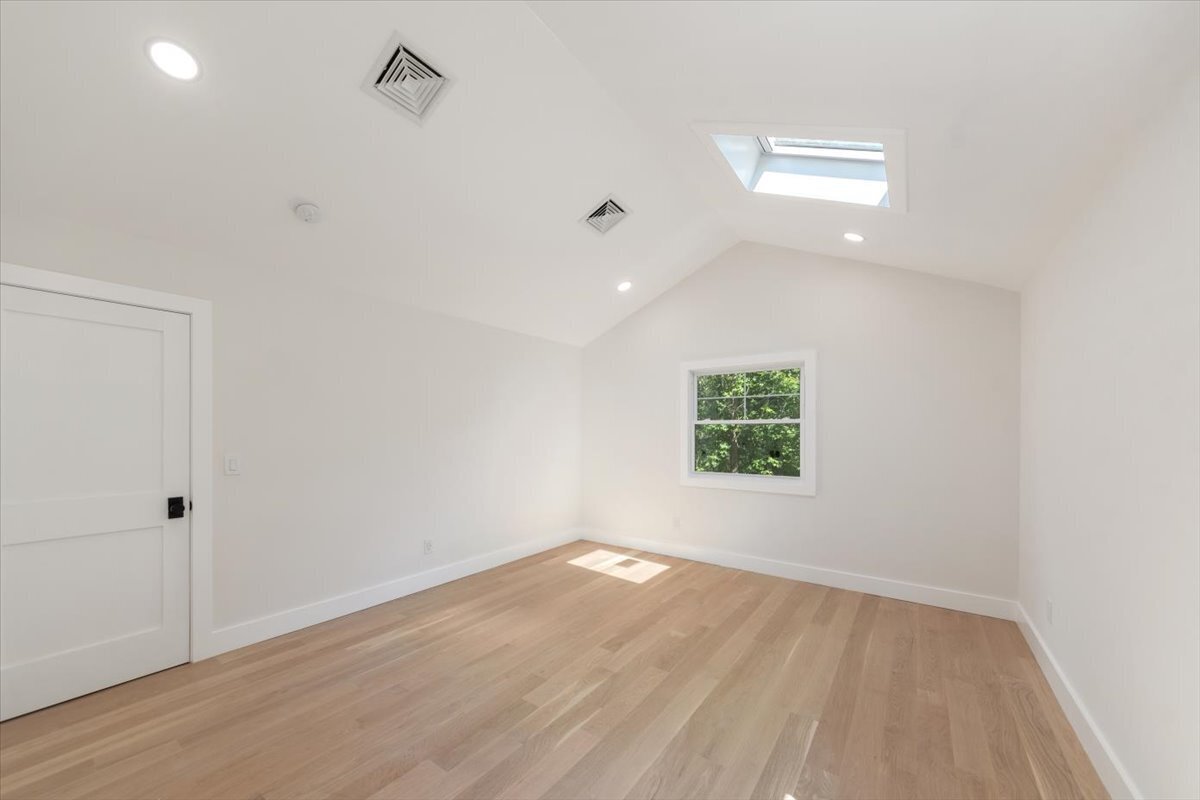 115 Mayfair Road Fairfield, CT 06824 - Photo 24 of 36 an empty room with wooden floor and windows