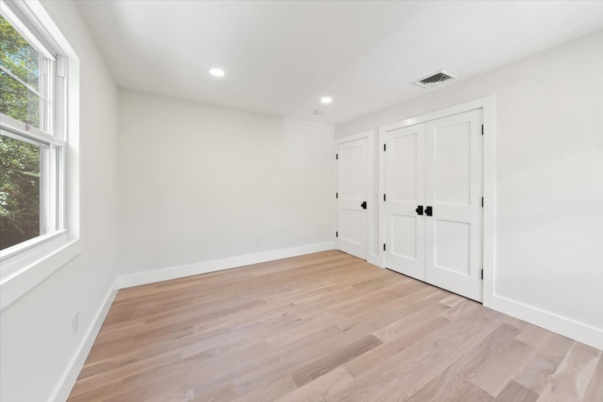 115 Mayfair Road Fairfield, CT 06824 - Photo 29 of 36 a view of an empty room with wooden floor and a window