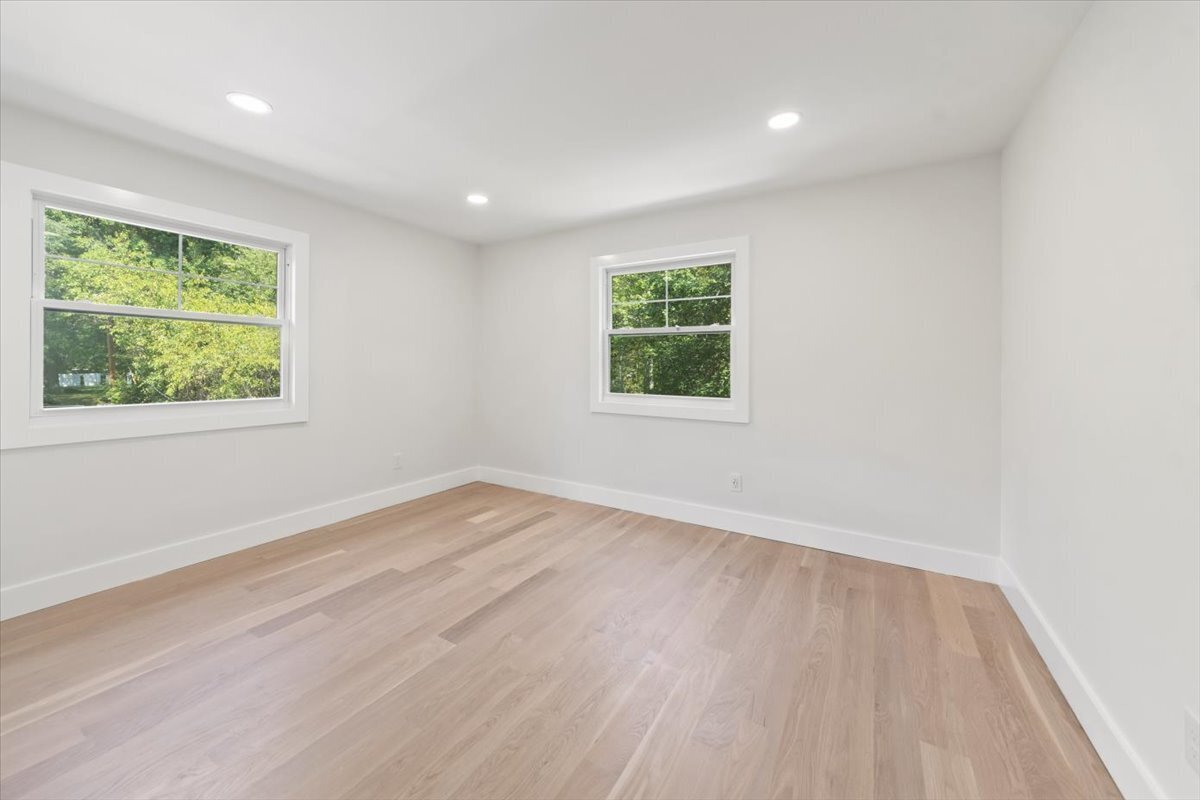 115 Mayfair Road Fairfield, CT 06824 - Photo 30 of 36 an empty room with wooden floor and windows