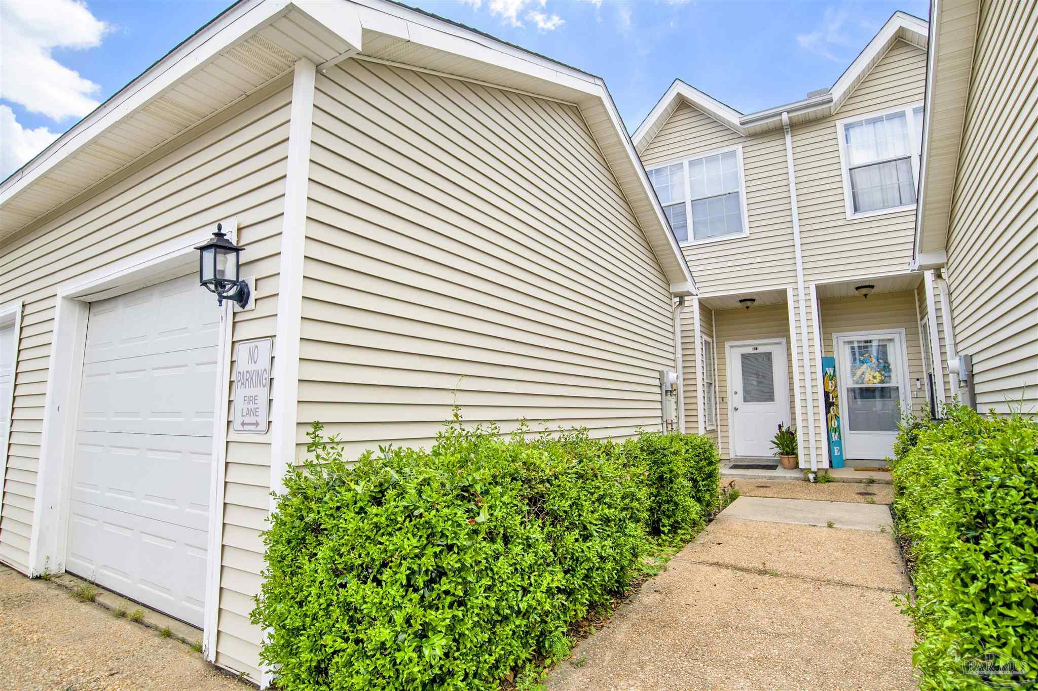 601 East Burgess Road, Unit K11 Pensacola, FL 32504 - Photo 1 of 34 a view of a white house with a small entryway