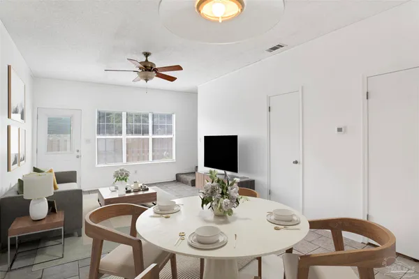 a view of a dining room with furniture and wooden floor