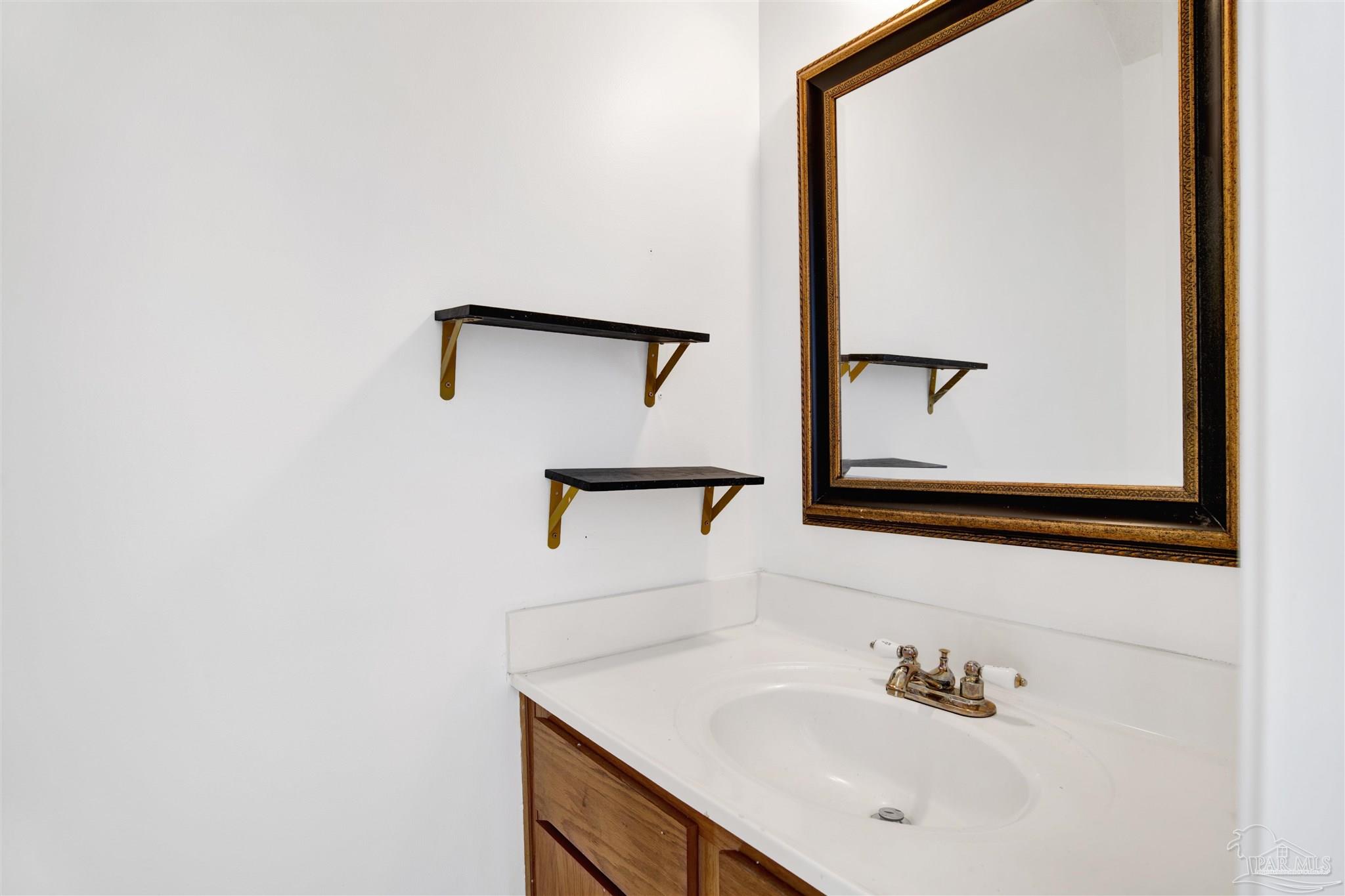 601 East Burgess Road, Unit K11 Pensacola, FL 32504 - Photo 16 of 34 a bathroom with a sink and a mirror