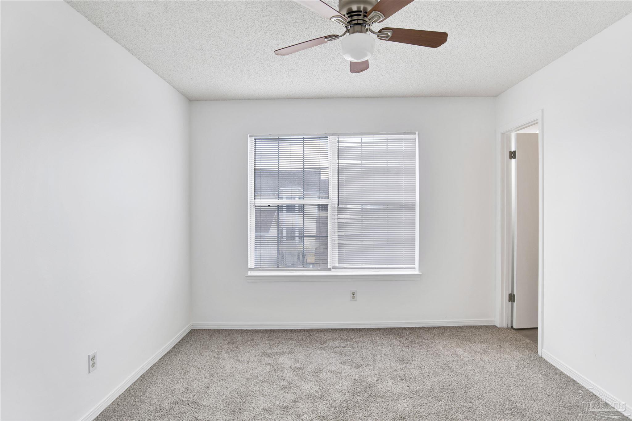 601 East Burgess Road, Unit K11 Pensacola, FL 32504 - Photo 19 of 34 an empty room with a window and a fan