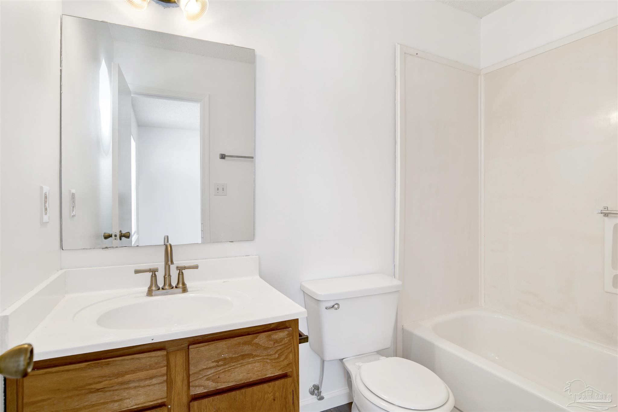 601 East Burgess Road, Unit K11 Pensacola, FL 32504 - Photo 21 of 34 a bathroom with a sink toilet vanity and tub