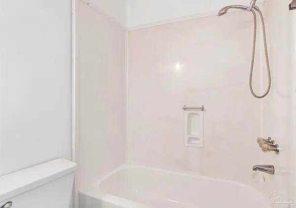 a bathroom with a bath tub with a shower