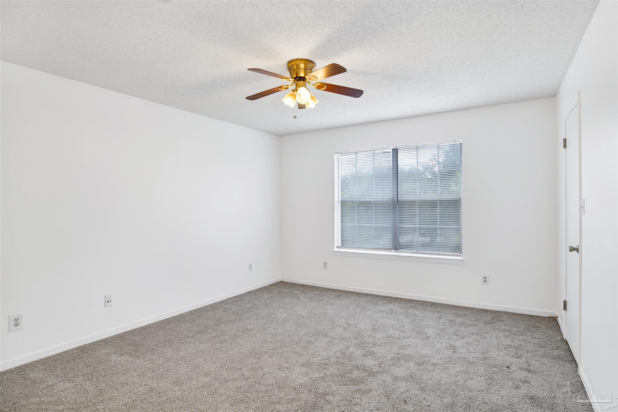 601 East Burgess Road, Unit K11 Pensacola, FL 32504 - Photo 25 of 34 an empty room with a window and a ceiling fan