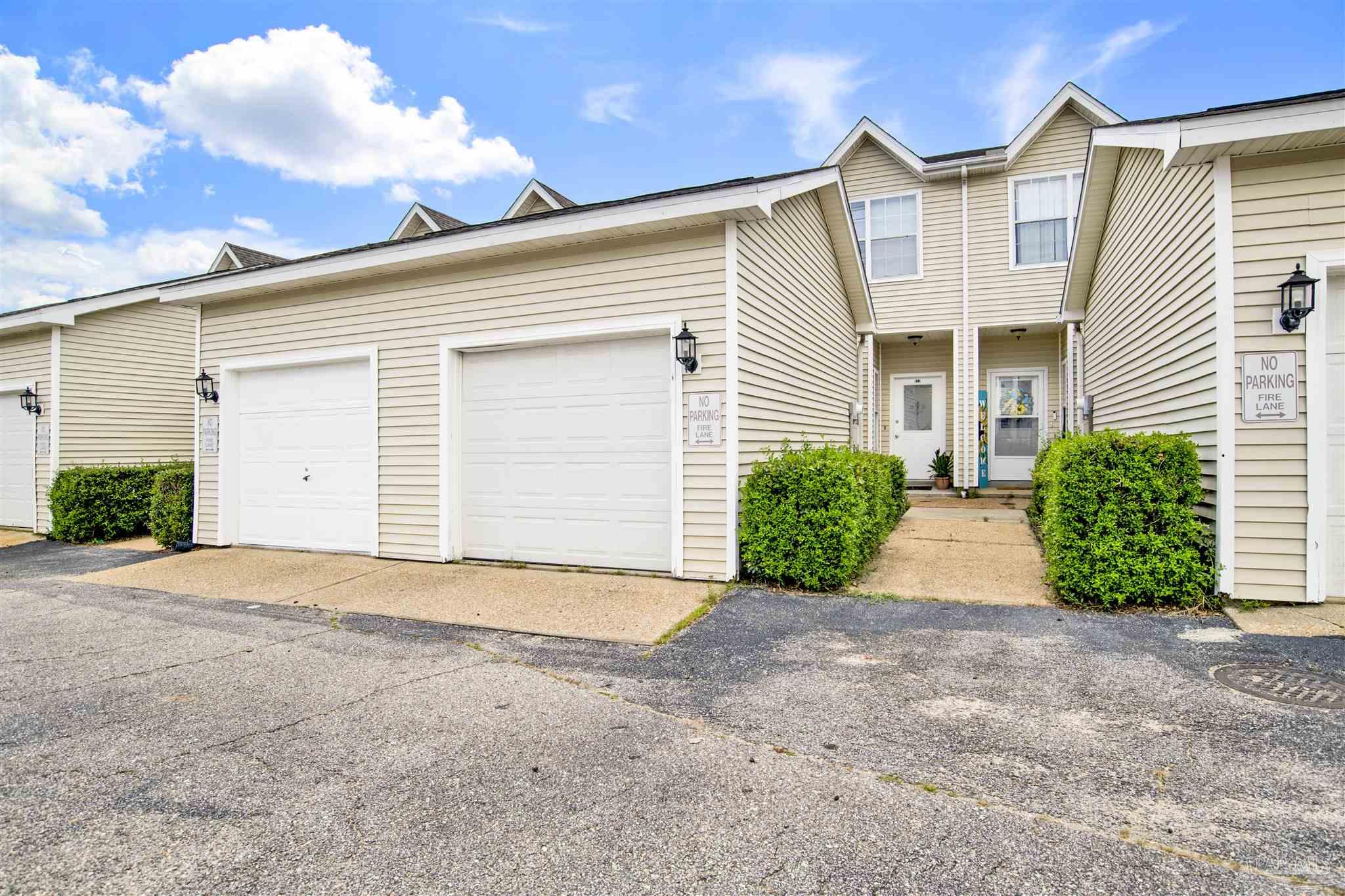 601 East Burgess Road, Unit K11 Pensacola, FL 32504 - Photo 34 of 34 a view of a house with a yard and garage