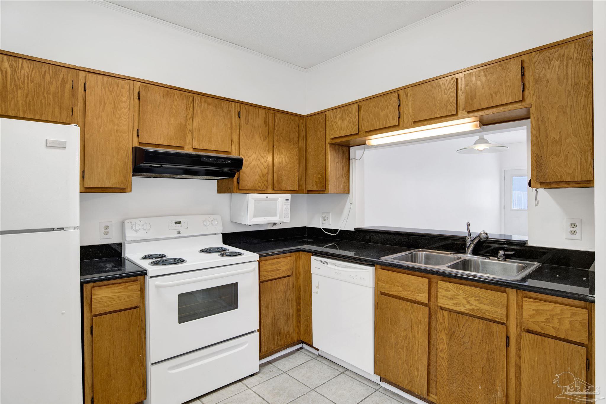 601 East Burgess Road, Unit K11 Pensacola, FL 32504 - Photo 5 of 34 a kitchen with stainless steel appliances a stove a sink and a refrigerator