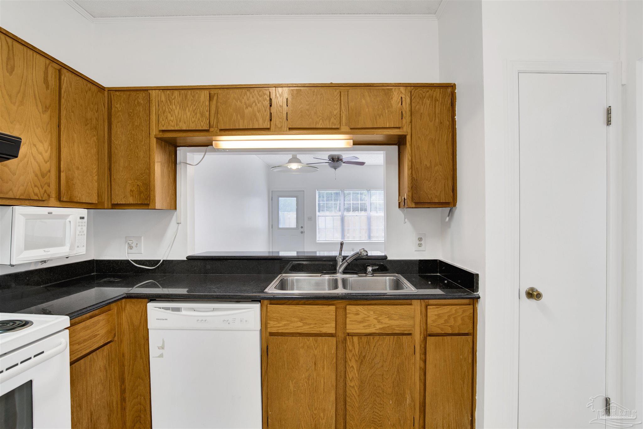 601 East Burgess Road, Unit K11 Pensacola, FL 32504 - Photo 6 of 34 a kitchen with a sink and cabinets